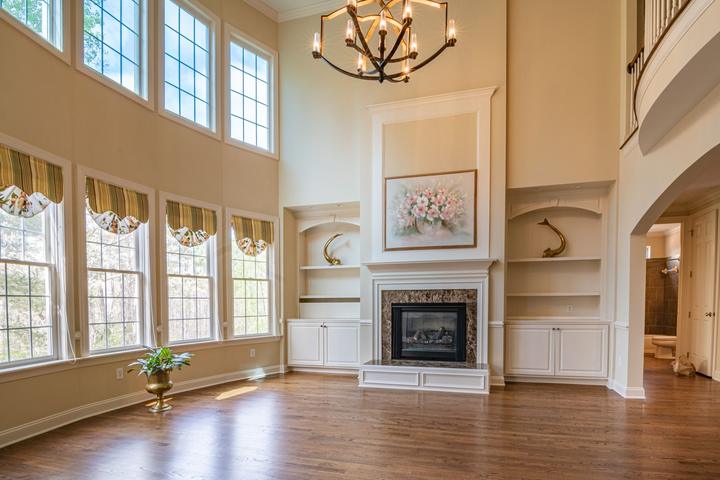 White fireplace and built-in cabinetry in a bright room